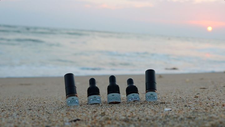 Image of Hempeutics CBD products on the beach.