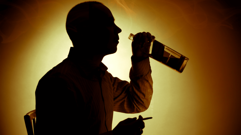 Image showing man struggling with alcohol and nicotine cravings.